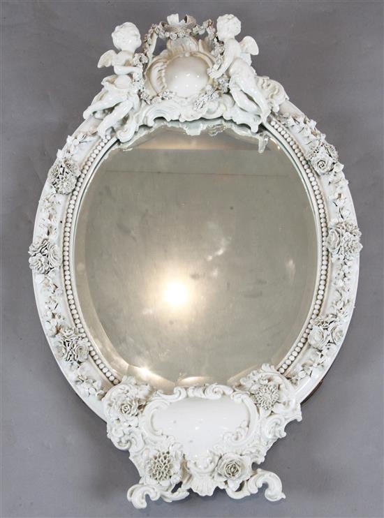 A late 19th century German porcelain wall mirror, W.57cm. H.90cm